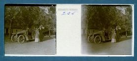[Man and woman posing by car]