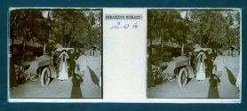 [Three people posing by car]