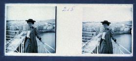 [Woman on balcony overlooking city]