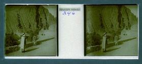 [Man in foreground with woman and mountains in backround]
