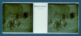 [Two women and guide posing in front of stone building - children watc]