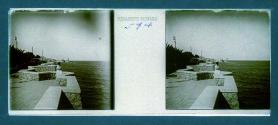 [Woman on stone pier by lake]