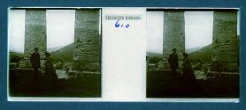 [Man and woman at base of columns]