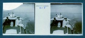 [Woman posing next to captain(?) of boat]