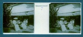 [Two unid. women seated in cafe]