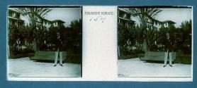 [Unid. man standing in front of hotel]