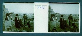 [Unid. group seated near architectural ruins]