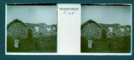 [People in front of building made of piled stones]