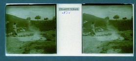 [Unid. woman standing next to hot springs]