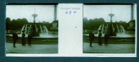 [Unid. woman and two men in front of fountain]
