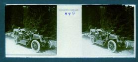 [Unid. woman with goggles in back seat of car]