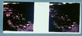 [Two unid. men on deck chairs]