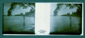 [Unid. man wading in water]