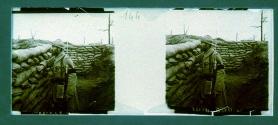 [WWI soldier peering over sandbags]