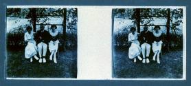 [Man and two women seated in garden]