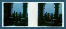 [Three people on cafe balcony]