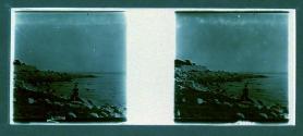 [Man on rocks by water]