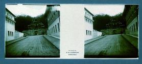 [View of street and stone building on side of hill]