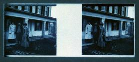 [Two women, one man on porch]