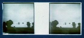 [Three people along river bank]