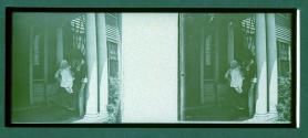 [Woman holding child on porch]