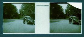[Man in uniform next to car on street]