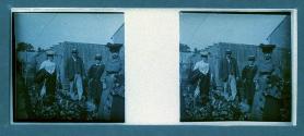 [Three women, one man in garden]