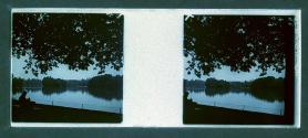 [Man on bench at riverbank]
