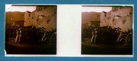 [Two women, one boy posing in front of old fort]