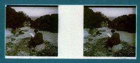 [Man and woman seated on rocks]