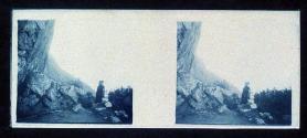 [Woman standing by rocks]