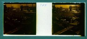 [Three people standing in boat at dock]
