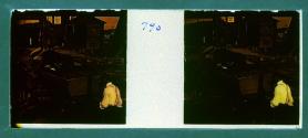 [Three people working on boat in shipyard]
