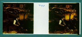 [Two unid. men working on boat in shipyard]