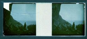 [Unid. woman on cliffs overlooking water]