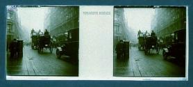 [Horse and carriages and cars on London street]