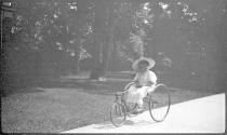 Small child on three wheel bike