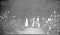 Group of women walking on garden path