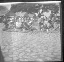People sitting on ground at public market