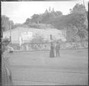 Man and woman on street-cathedral on hill