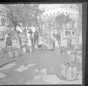 Men and women selling something on street