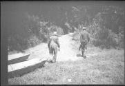 Men with boats by stream