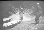 Man with boats by stream