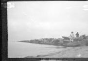 Two people standing on shore