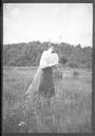 Woman walking in tall grass