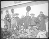 Group portrait of children on deck of boat