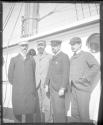 Group of men standing on deck