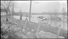 [Car on flooded road]