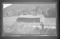 [Man photographing building with carriage on roof]