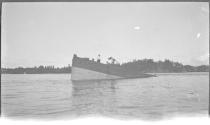 [Men on wrecked ship in river]